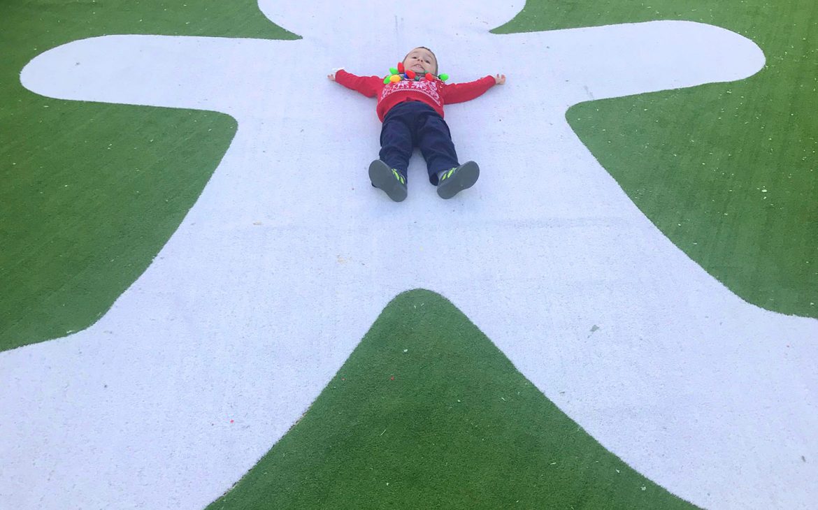 A tired little boy lying in a giant cookie