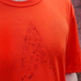 closeup of star trek delta design on orange running shirt