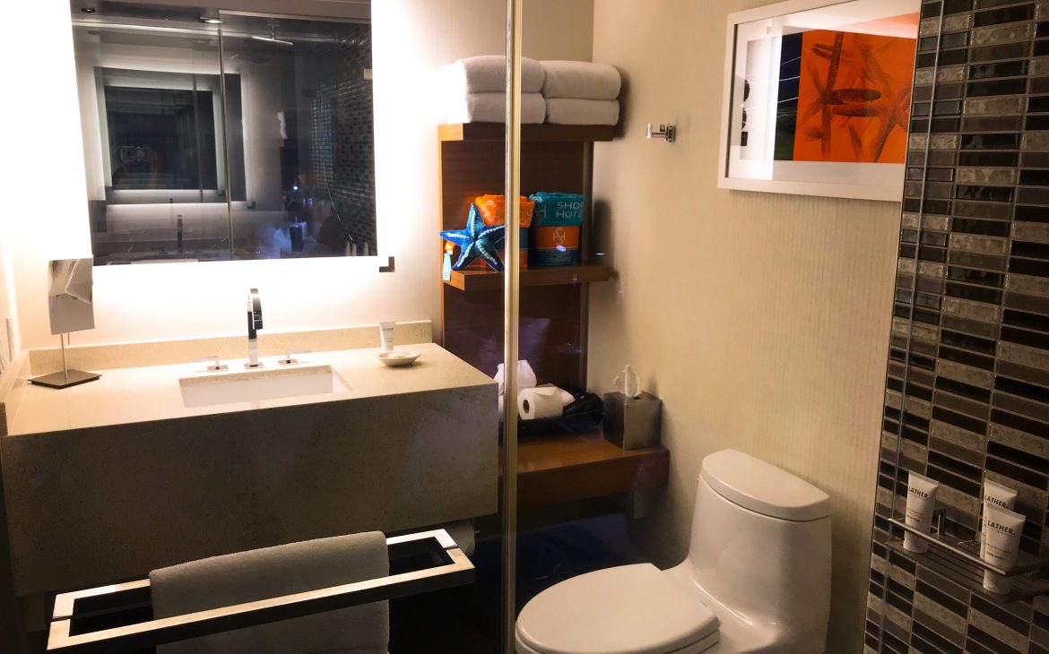 the bathroom at The Shore Hotel Santa Monica, viewing the sink and toilet area