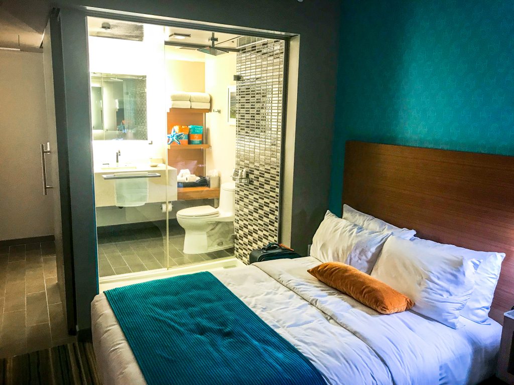 double bed standard room at The Shore Hotel Santa Monica, demonstrating the clear glass wall between the bedroom and the bathroom