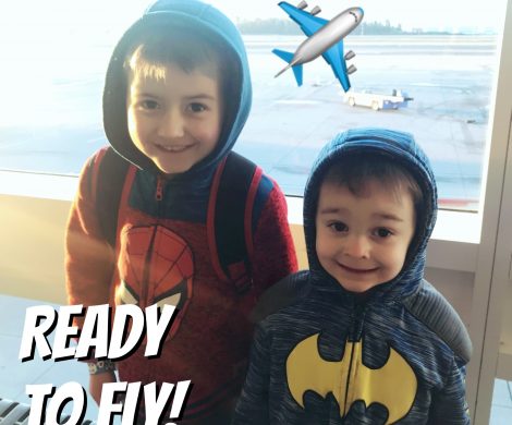 Two kids ready to fly on an airplane