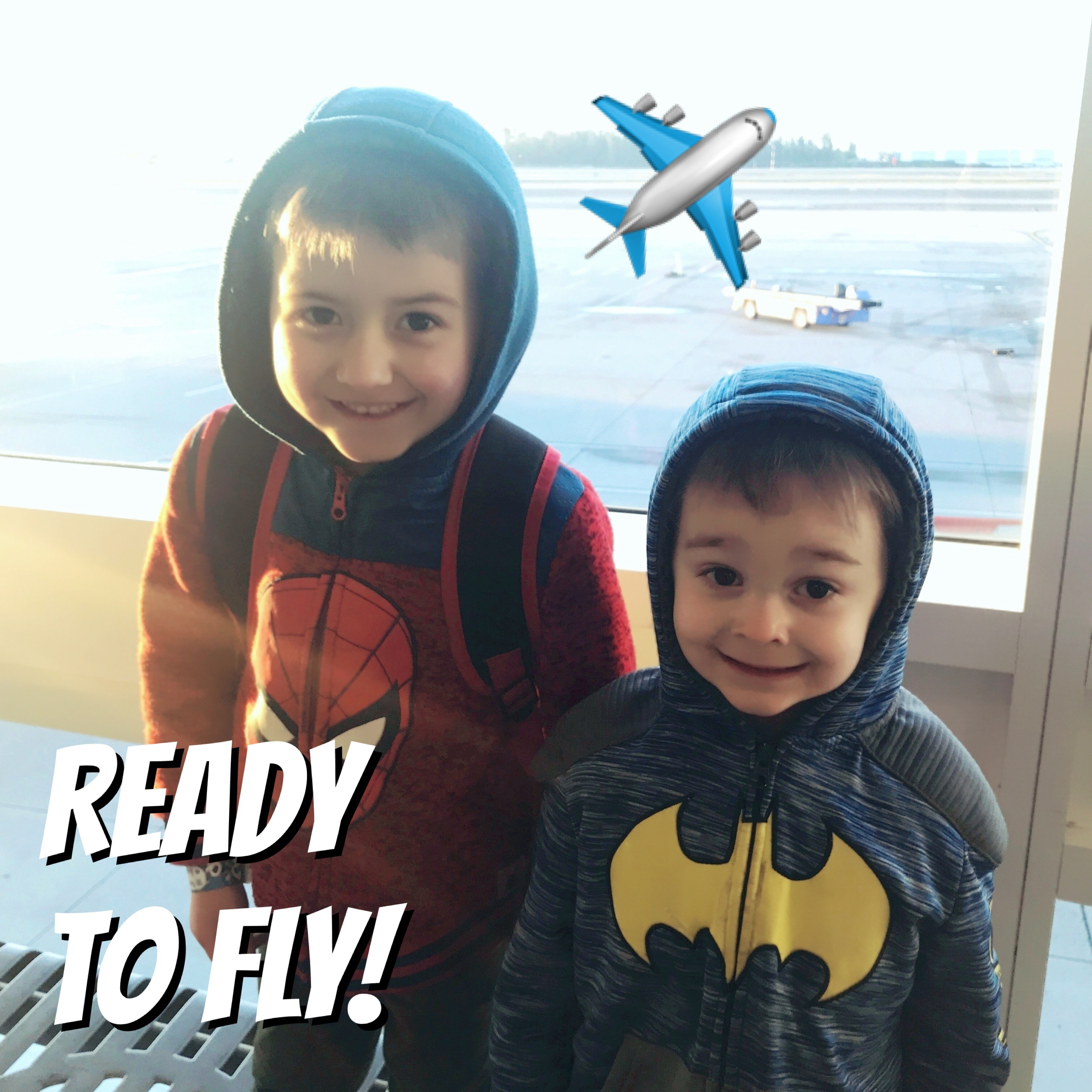 Two kids ready to fly on an airplane