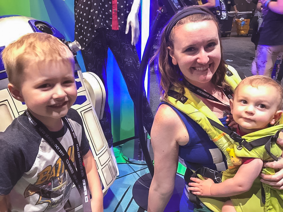 The Morgan family at SDCC, meeting R2D2. The baby is in a green Lillebaby carrier