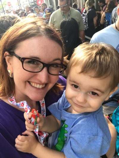 Laci Morgan and her son in front of a crowded sidewalk at SDCC