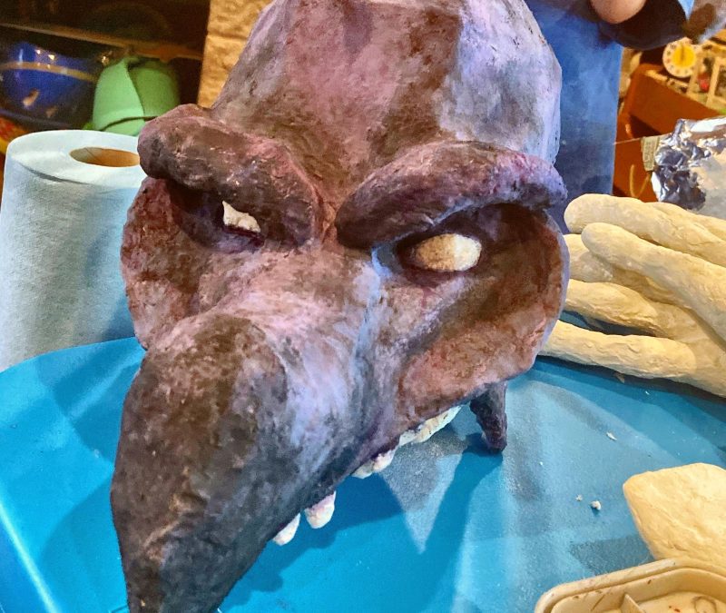 A painted paper mache Skeksis mask
