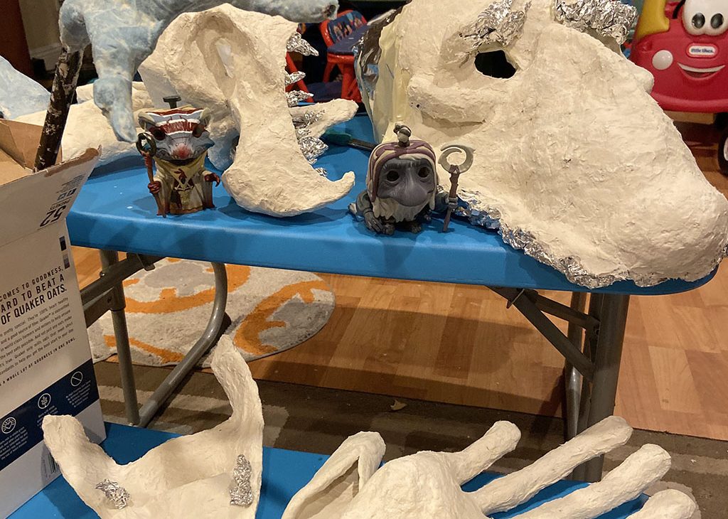 Masks and hands created out of paper mache clay