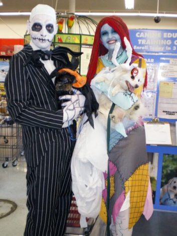 Jack Skellington and Sally cosplay Nightmare Before Christmas holding a dog and a cat