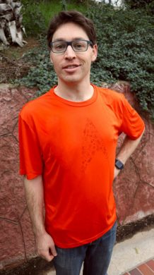 An orange running shirt with a Star Trek delta logo made out of starships